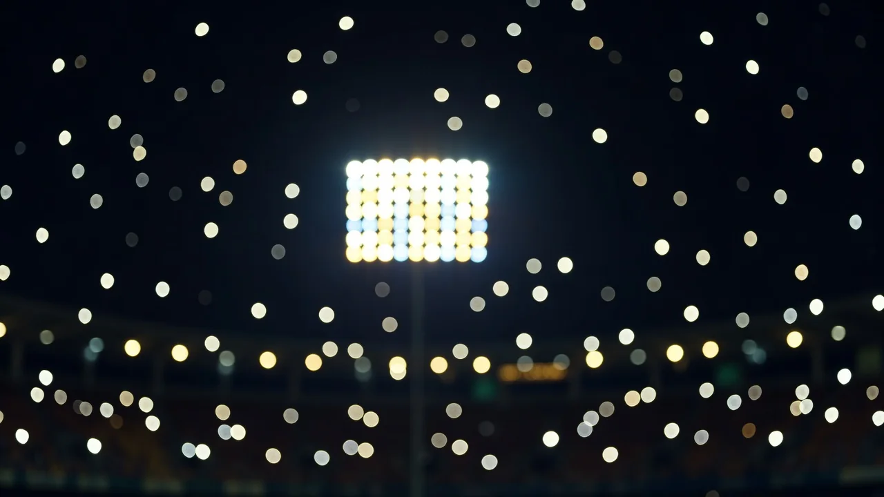 Painel eletrônico de estádio com luzes desfocadas à noite
